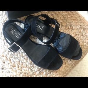 Barney’s low- heeled black sandal